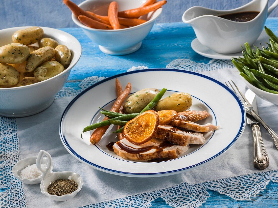 Turkey with carrots beans and potatoes on a plate