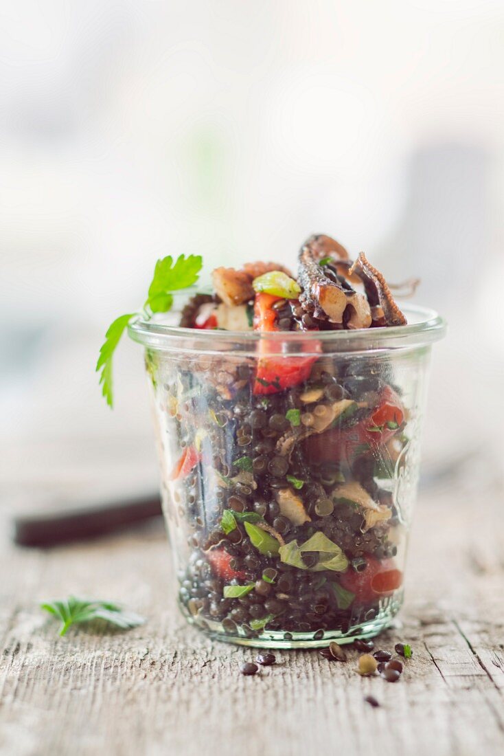 Lentil salad with octopus in a glass jar