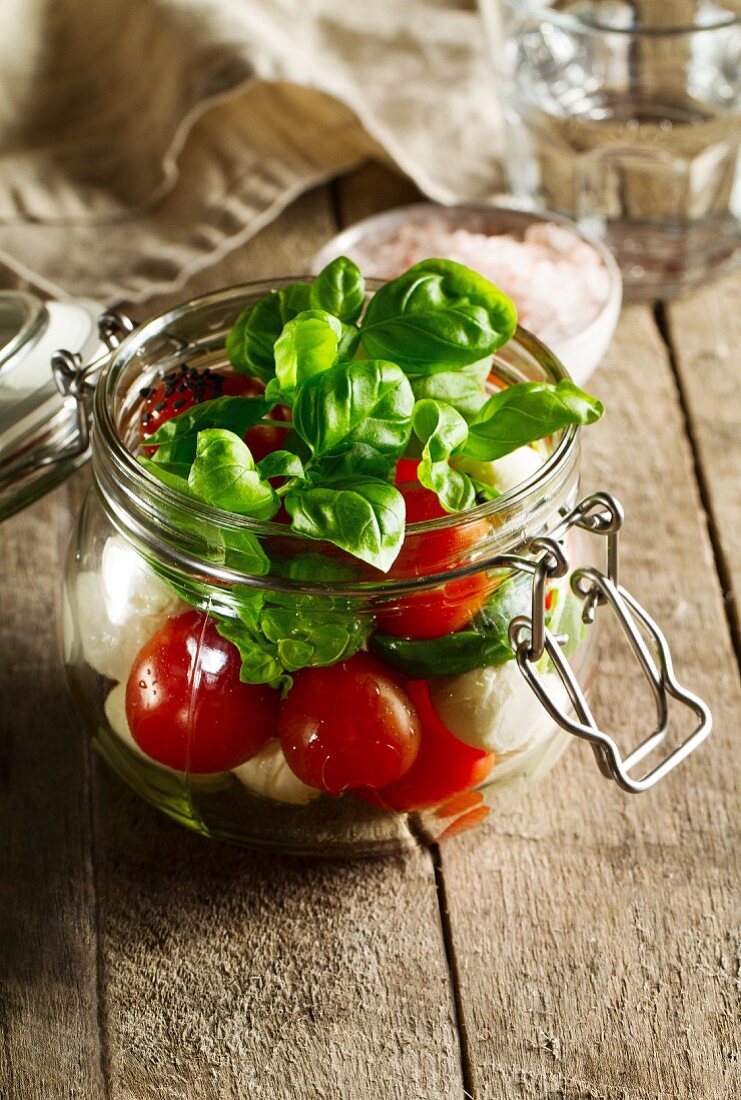 Tomato, mozzarella and basil in a glass jar