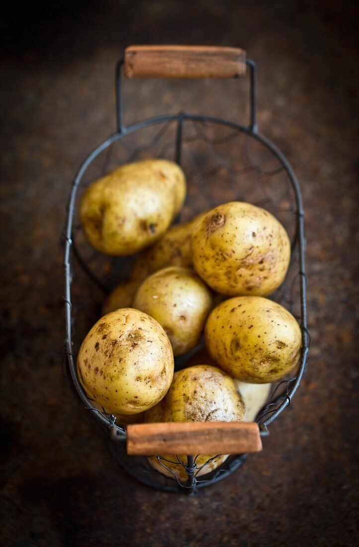 Fresh potatoes in a wire basket