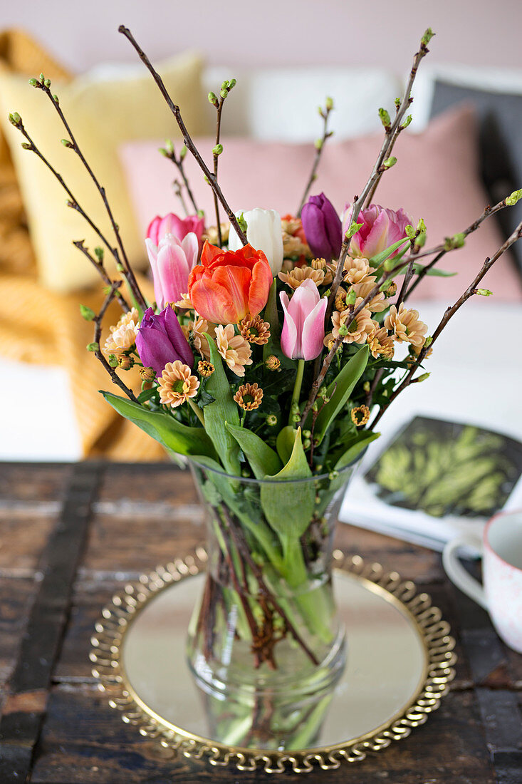 Spring bouquet of tulips, chrysanthemums and twigs
