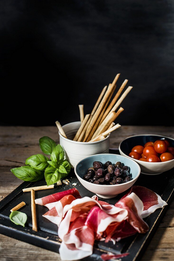Parma ham, grissini, olives and tomatoes