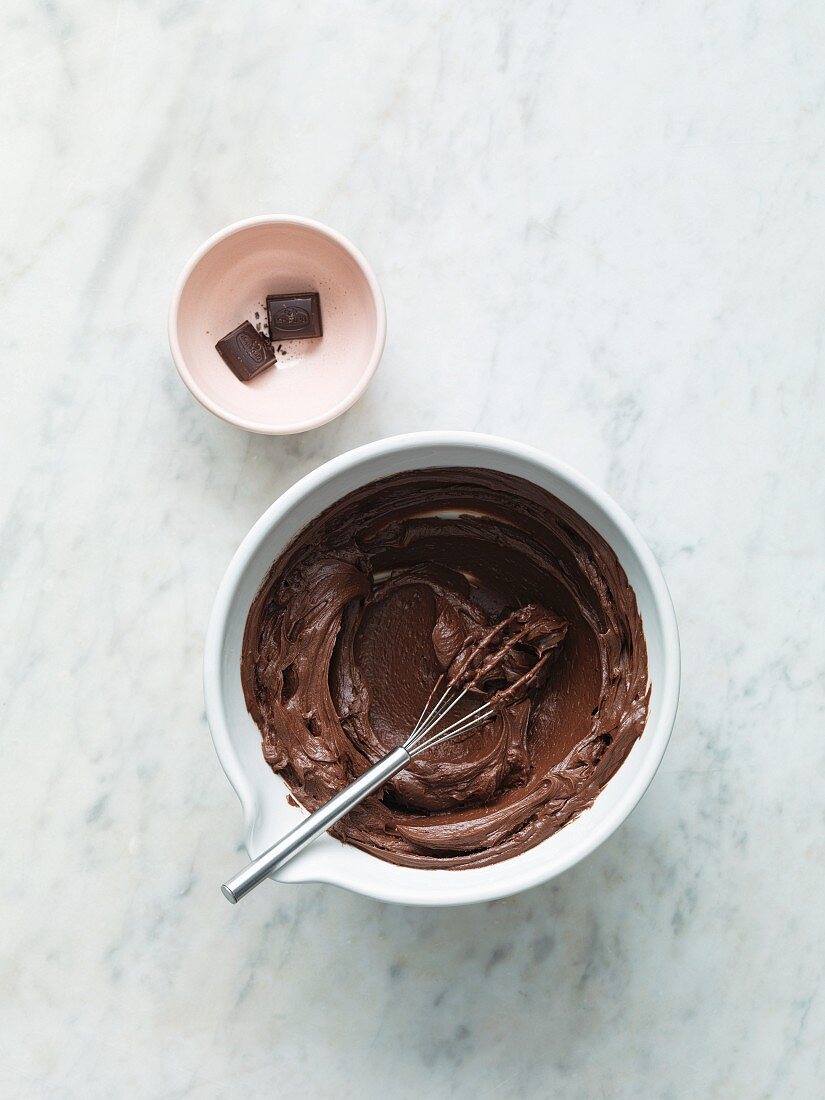 Melted chocolate in a bowl with a whisk