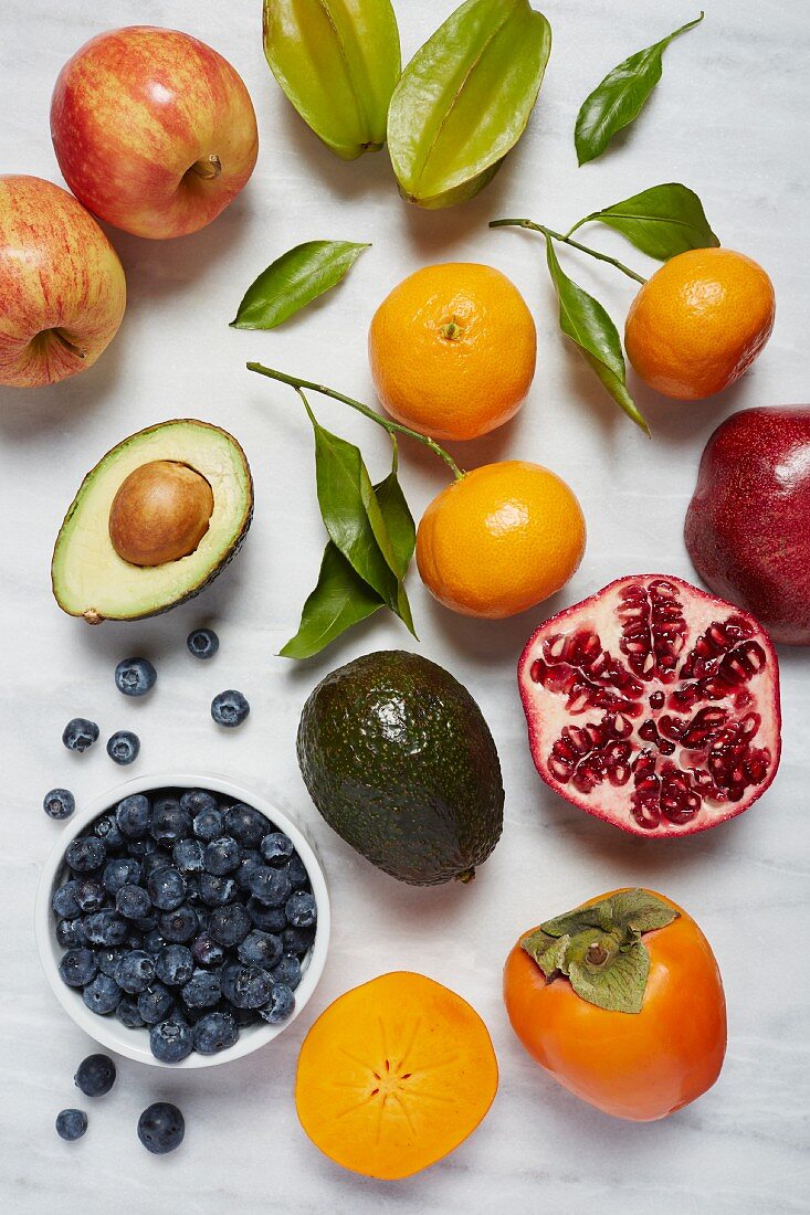 Fresh fruits and avocado on a white background