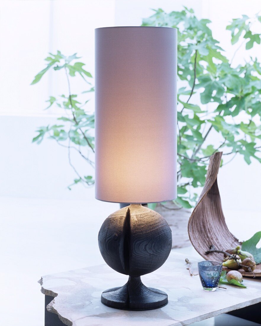 Table lamp with tall cylindrical lampshade and spherical base