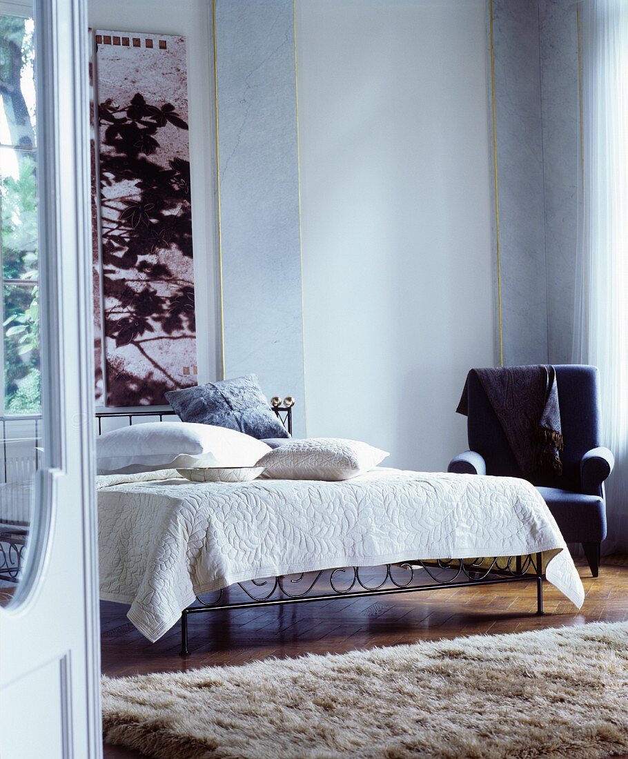 Metal bed and rug in classic bedroom