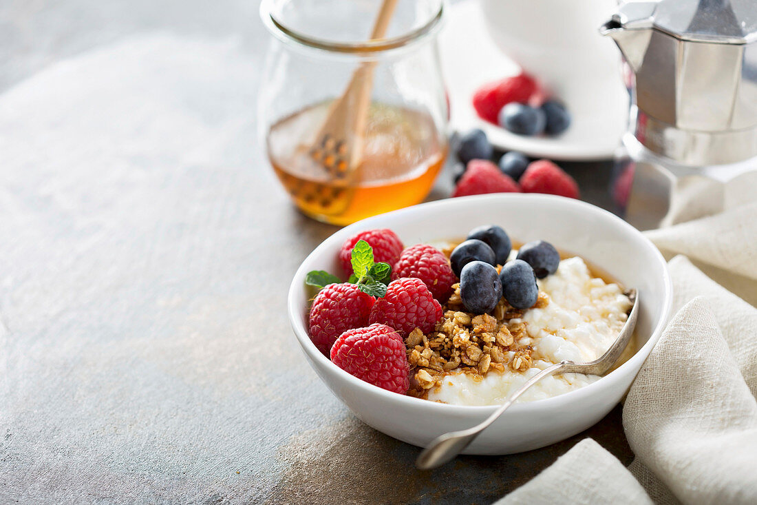 Cottage cheese for breakfast with granola, honey and raspberry