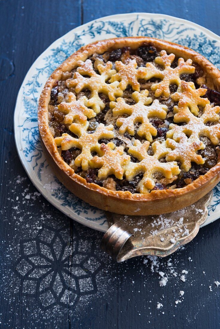 A mince pie with dried fruits and pastry stars