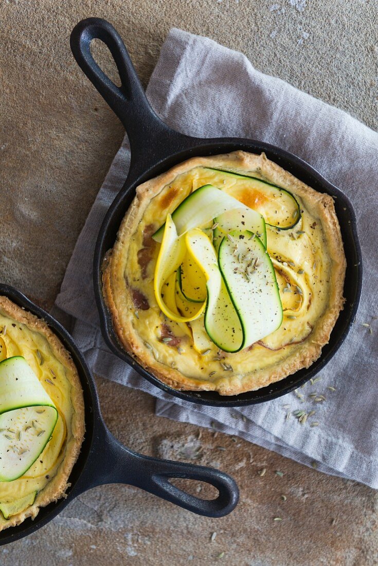 Courgette tarts in cast-iron pans