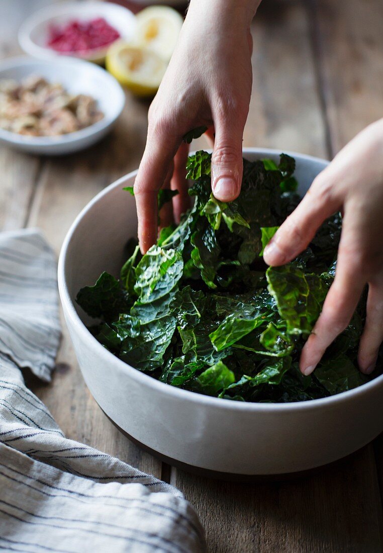 Mixing a kale salad