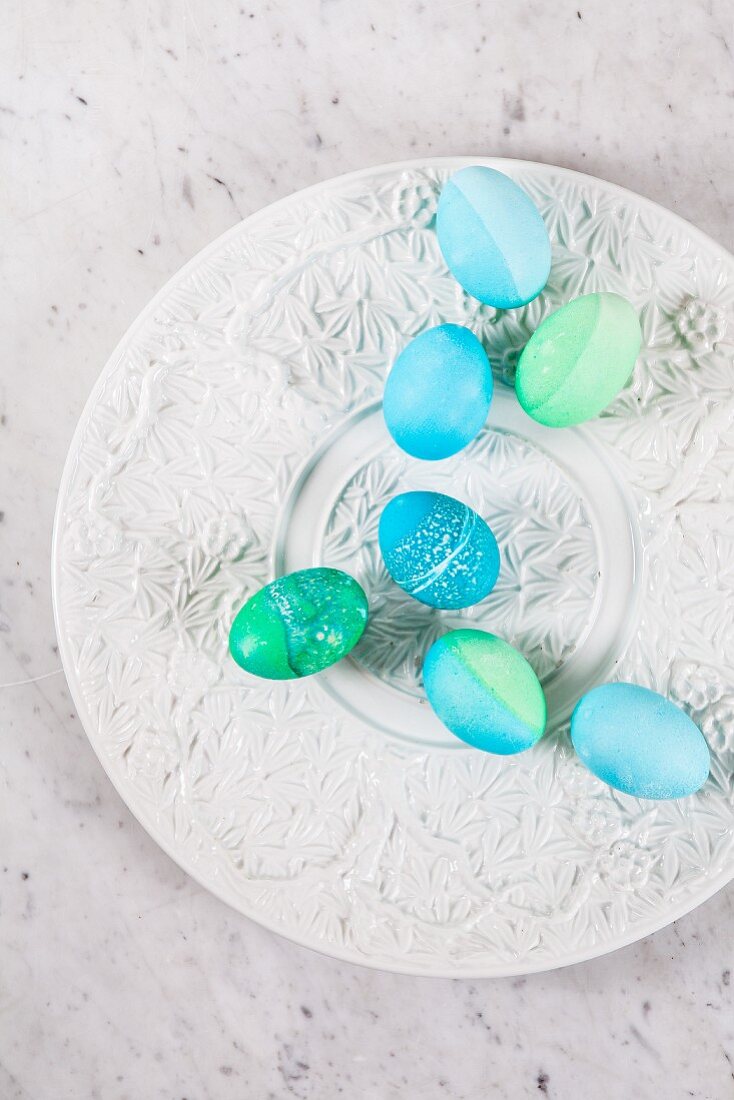 Dyed Easter eggs with batik patterns on a ceramic plate