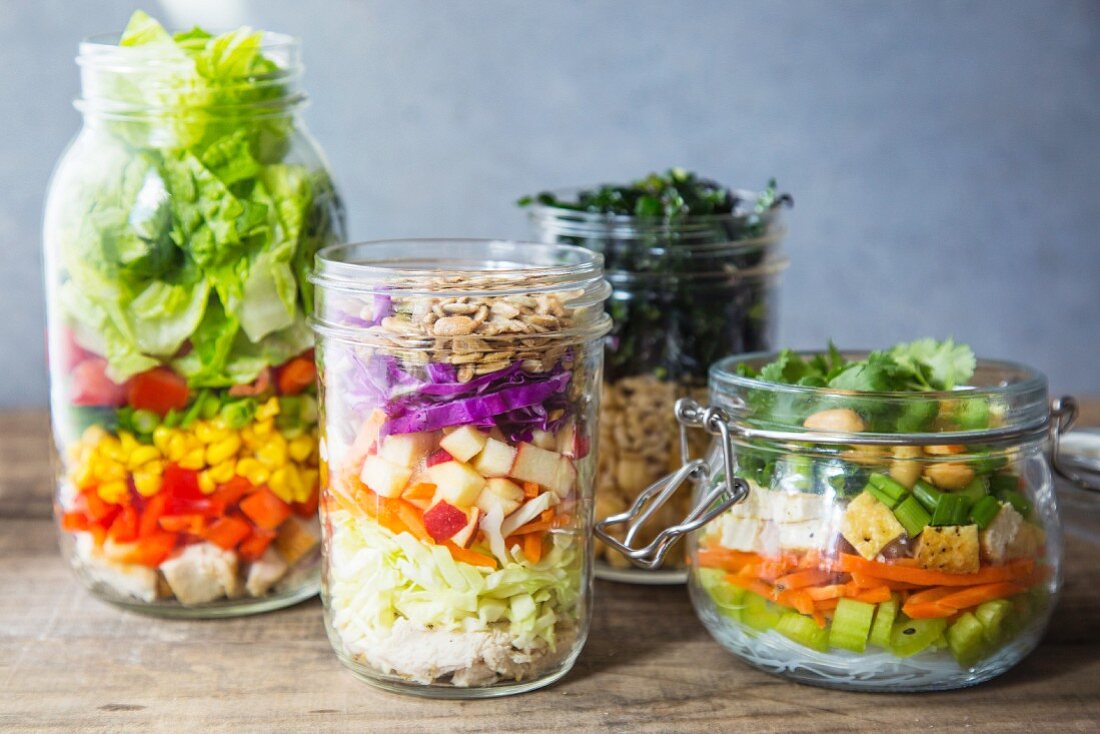 Various layered salads in glass jars
