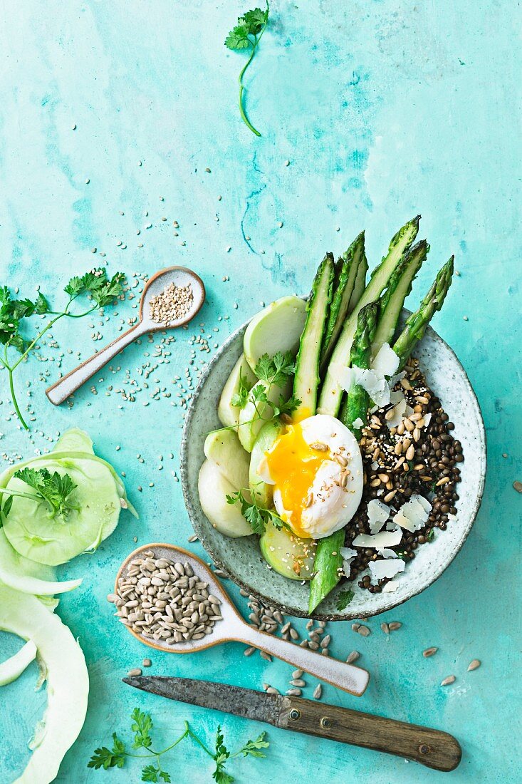An asparagus bowl with poached egg, kohlrabi and mixed seeds