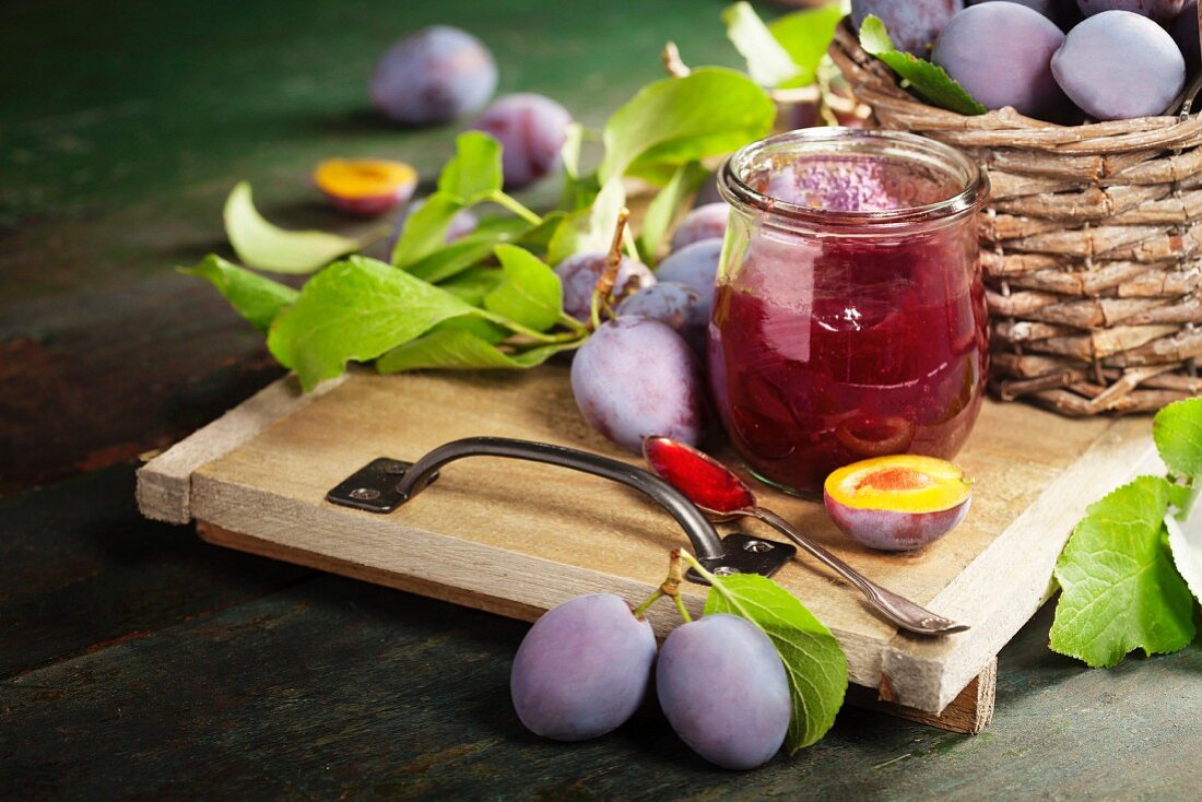 Sweet plums on wooden background, bio healthy fruits