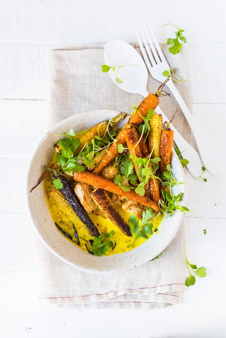 Turmeric soup with roasted root vegetables and baby corn