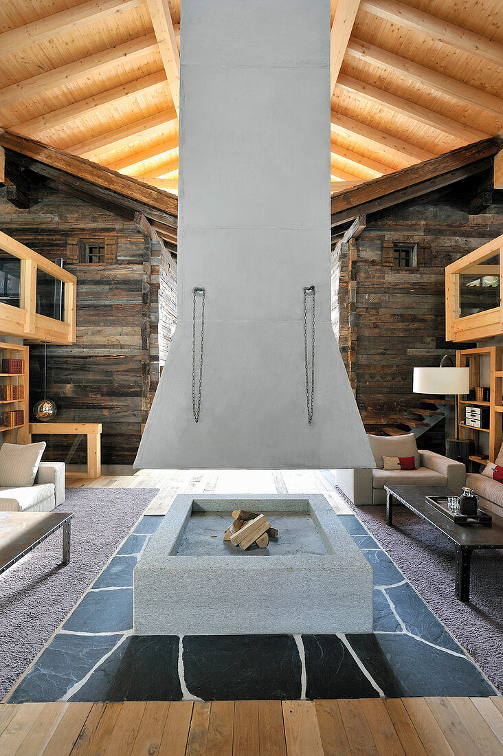 Fireplace below suspended chimney in architect-designed, Alpine house