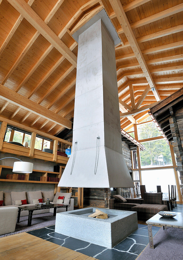 Fireplace below suspended chimney in architect-designed, Alpine house