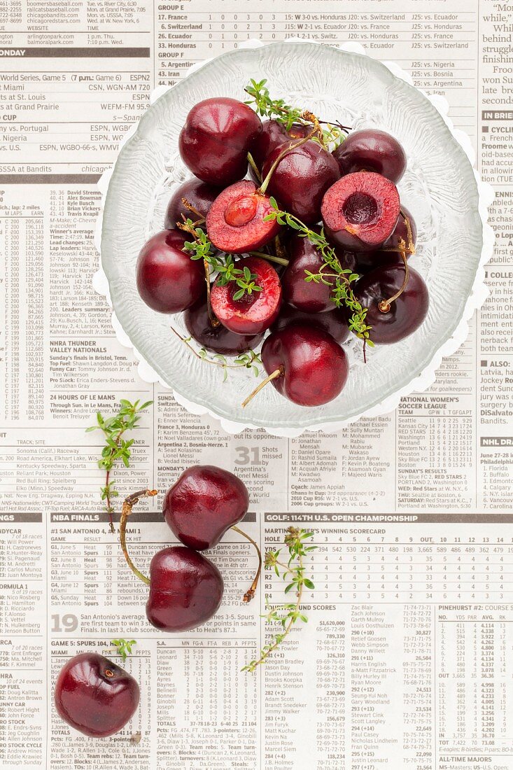 Fresh Cherries and Thyme on newspaper