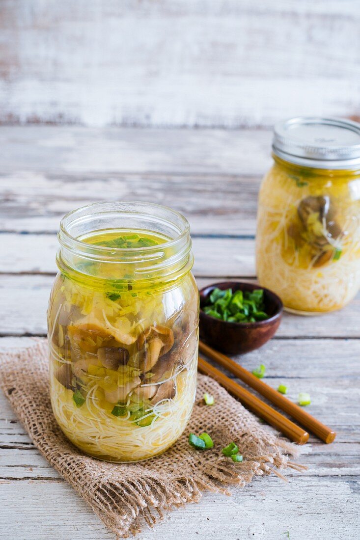 Mushroom and spring onion soup with rice noodles in a glass jar (Asia)