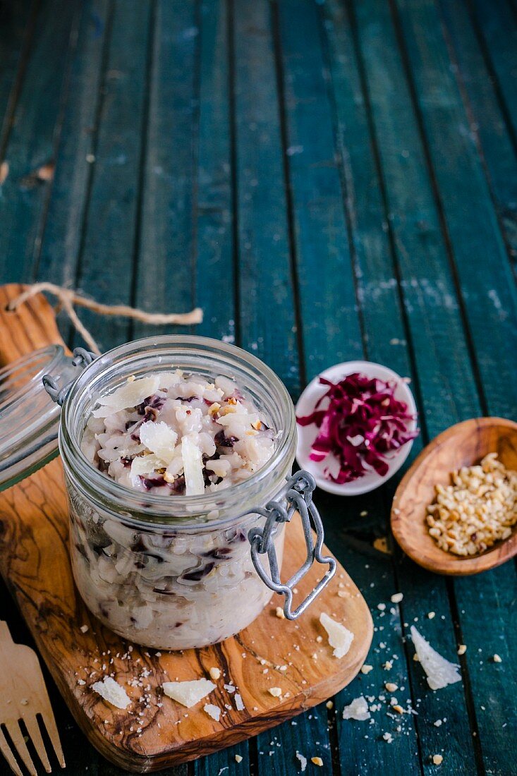 Radish risotto with parmesan and nuts in a glass jar