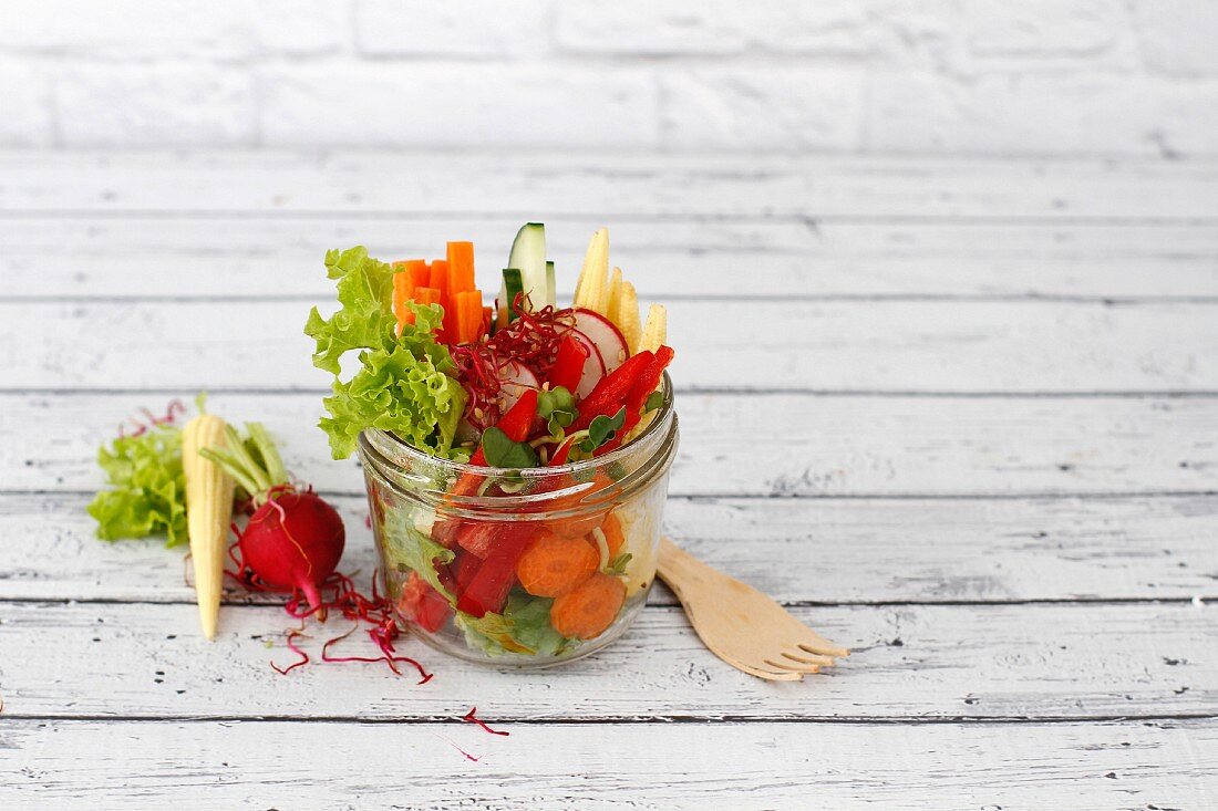 Healthy raw salad in a jar with space for text