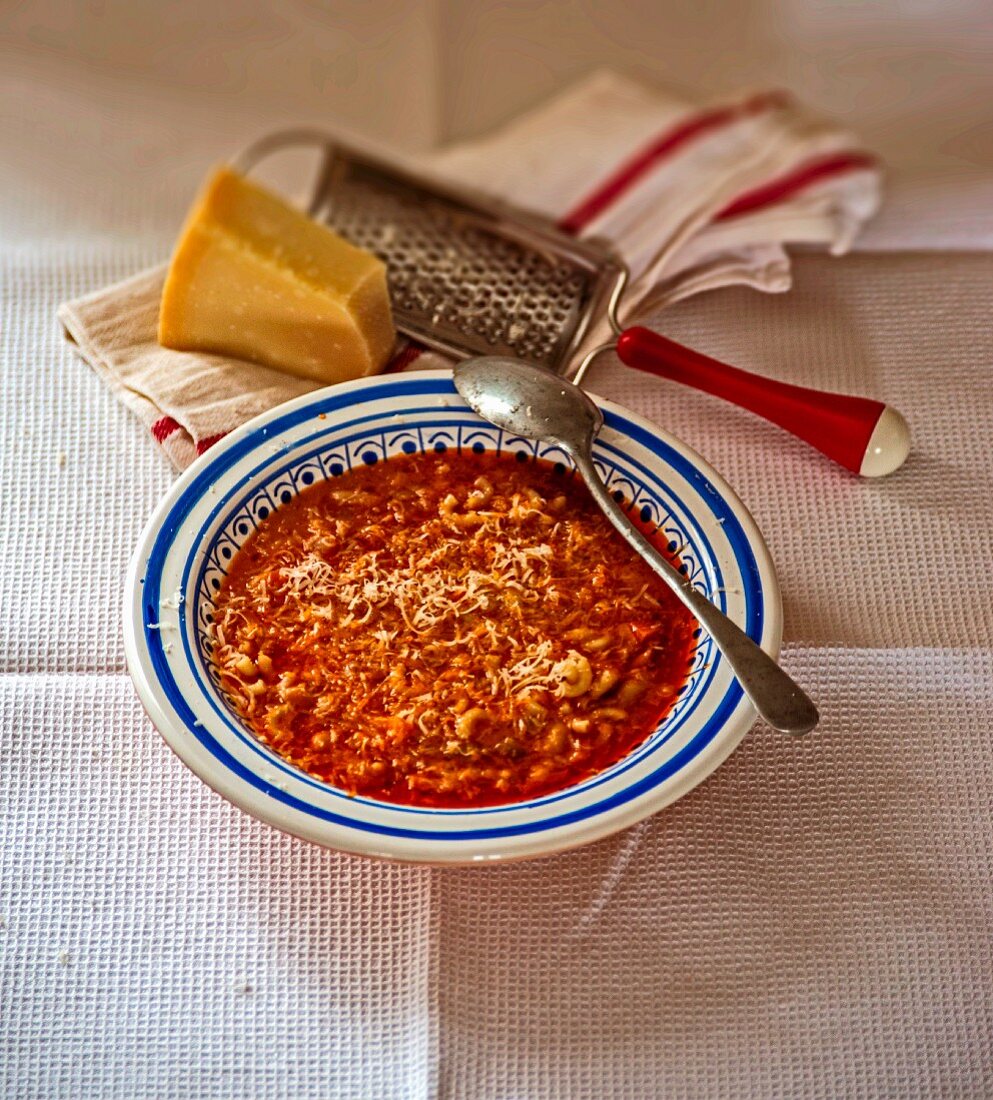 Pasta e fagioli (bean soup with noodles, Italy) topped with parmesan