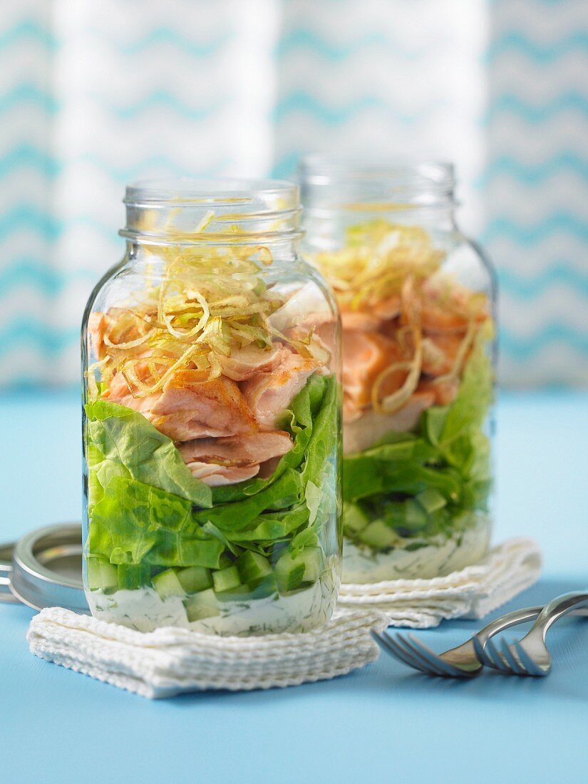 Lettuce with smoked salmon in glass jars