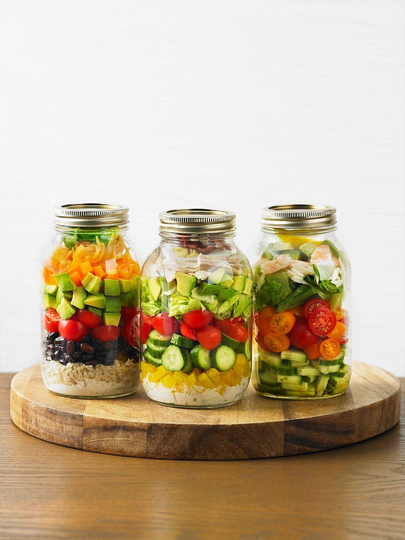 Various vegetable salads in a screw-top jars