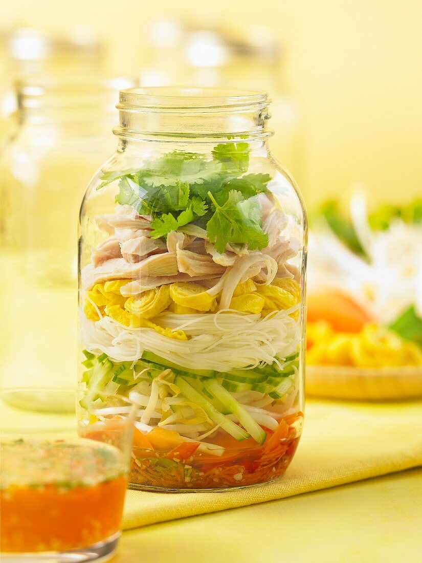Spring roll salad with chilli sauce in a glass jar (Asia)