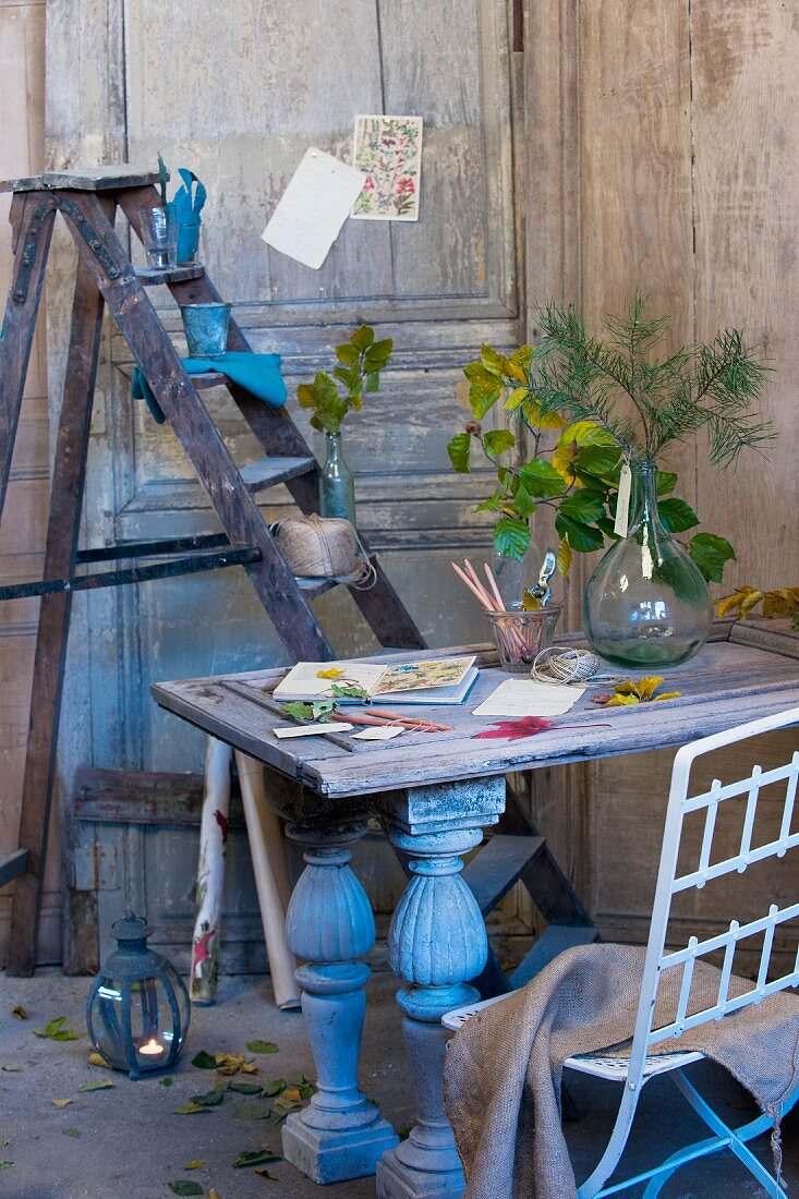 Autumnal arrangement on desk in front of stepladder used as shelves