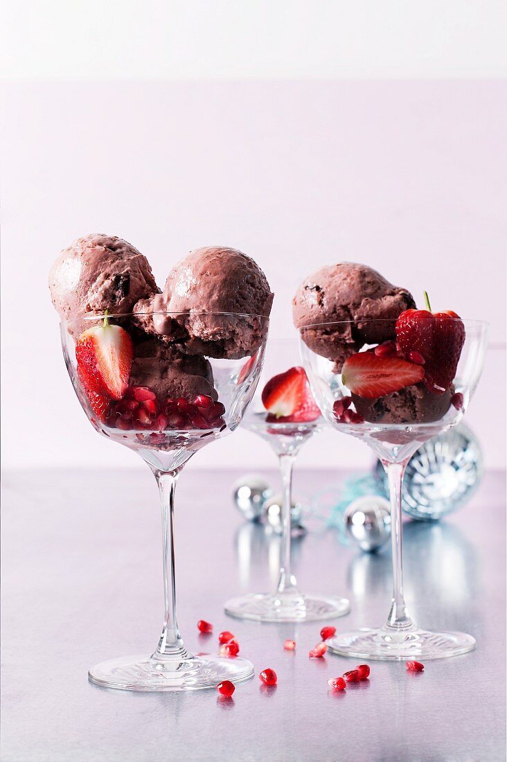Dark chocolate ice cream with strawberries and pomegranate seeds