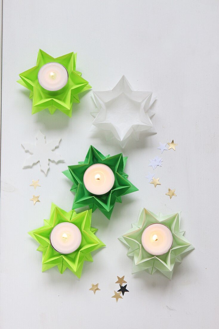 Folded green paper stars used as tealight holders