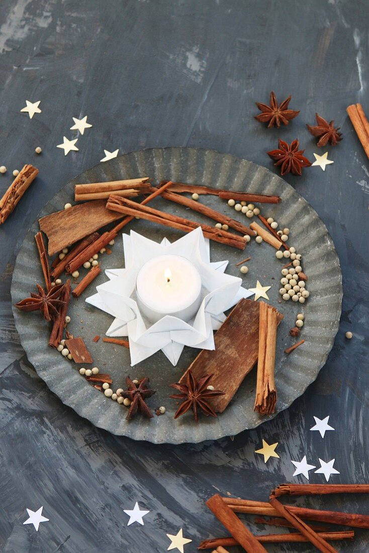 Folded white paper stars used as tealight holder