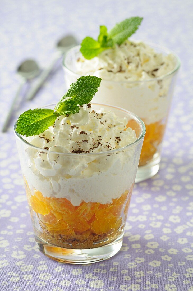 A mandarin dessert with cream in dessert glasses