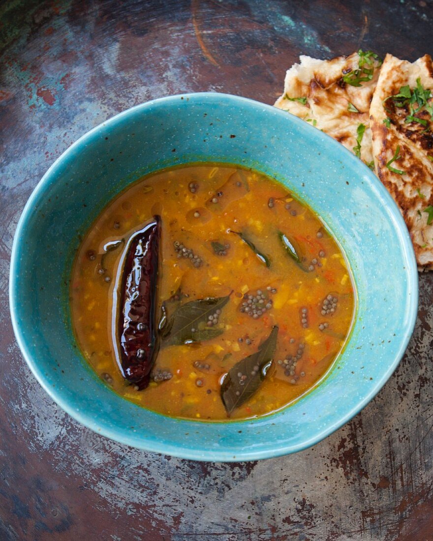 Indian rasam soup with flatbread