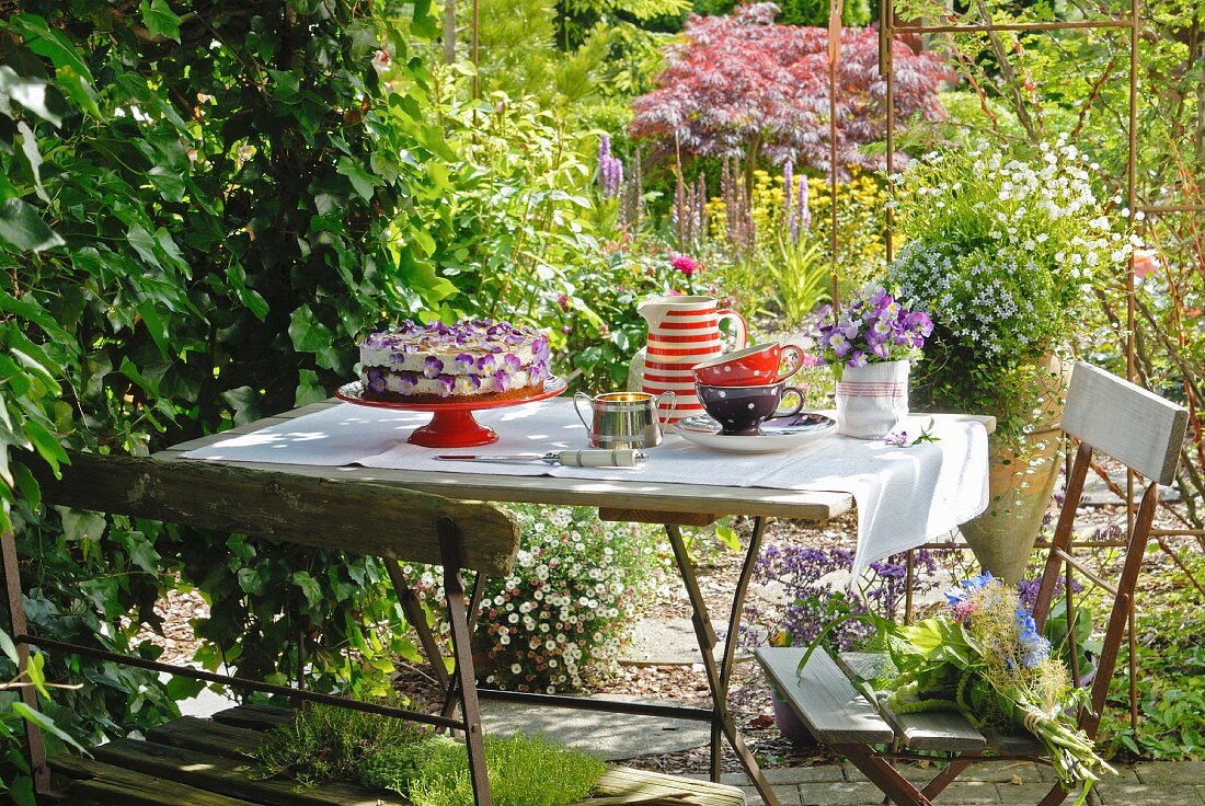 Caramel brittle cake and coffee service on garden table