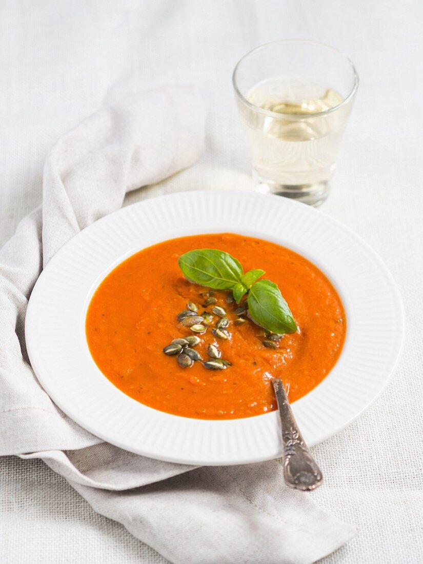 Tomato cream soup on white background