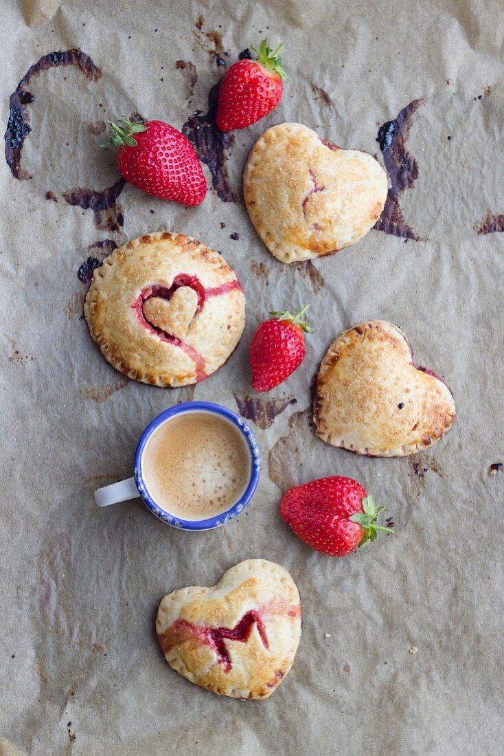 Hand pies (mini pies) with a strawberry filling and heart decorations