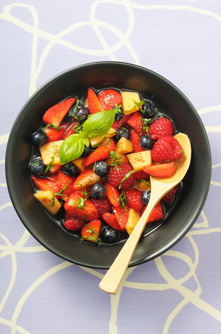Fruit salad with berries, melon and basil