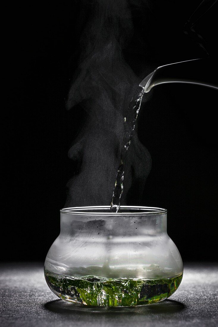 Pouring soup into a glass bowl