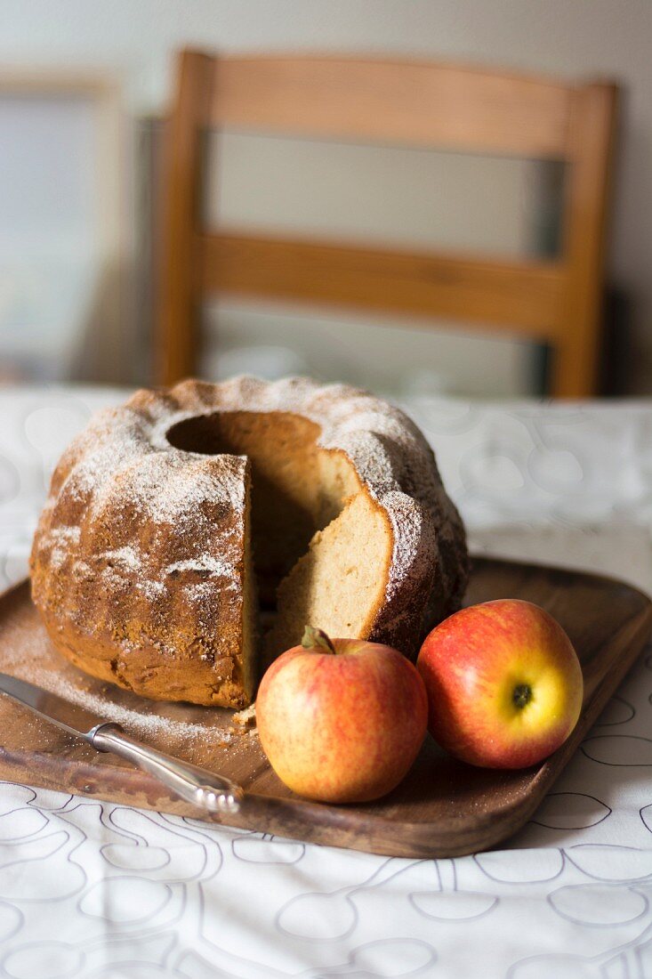 Apple gugelhupf, sliced, on a wooden tray