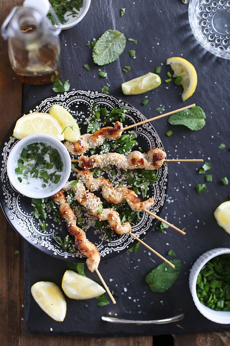 Chicken Shishkebabs with mint, sesme seeds and lemon wedges