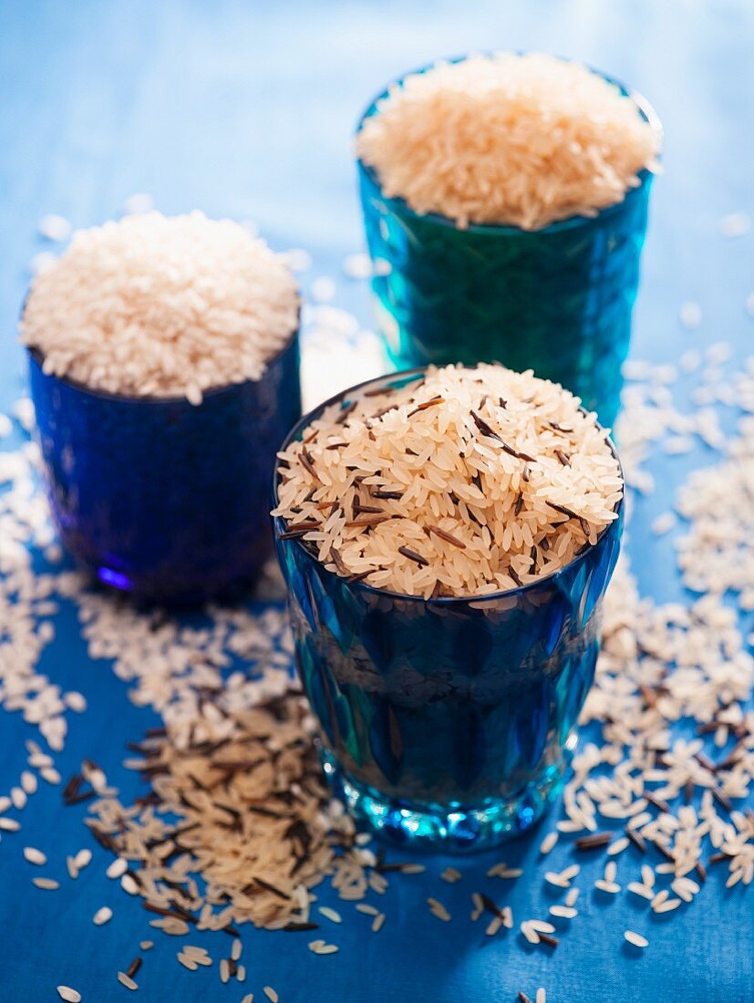 Different varieties of rice in blue glass jars