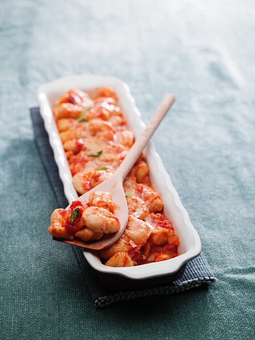 Shrimps with tomato sauce in an oblong serving dish