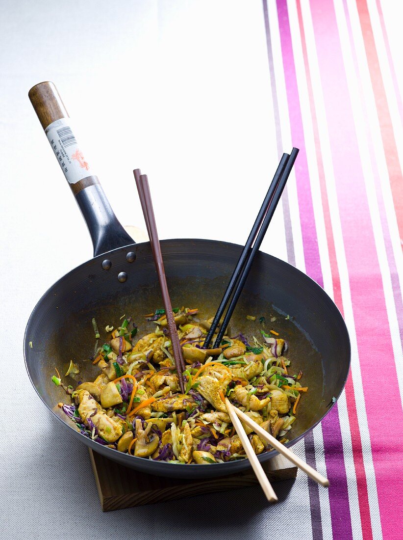 Chicken with mushrooms and red cabbage in a wok