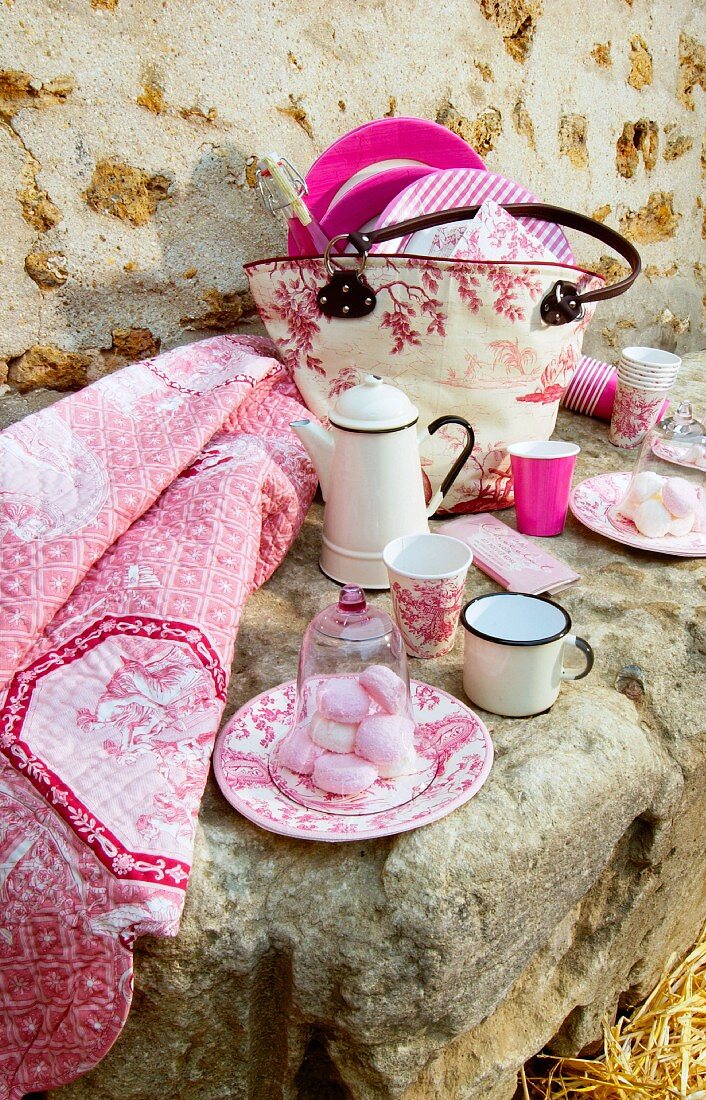 Picnic arranged on stone with vintage-style pink accessories
