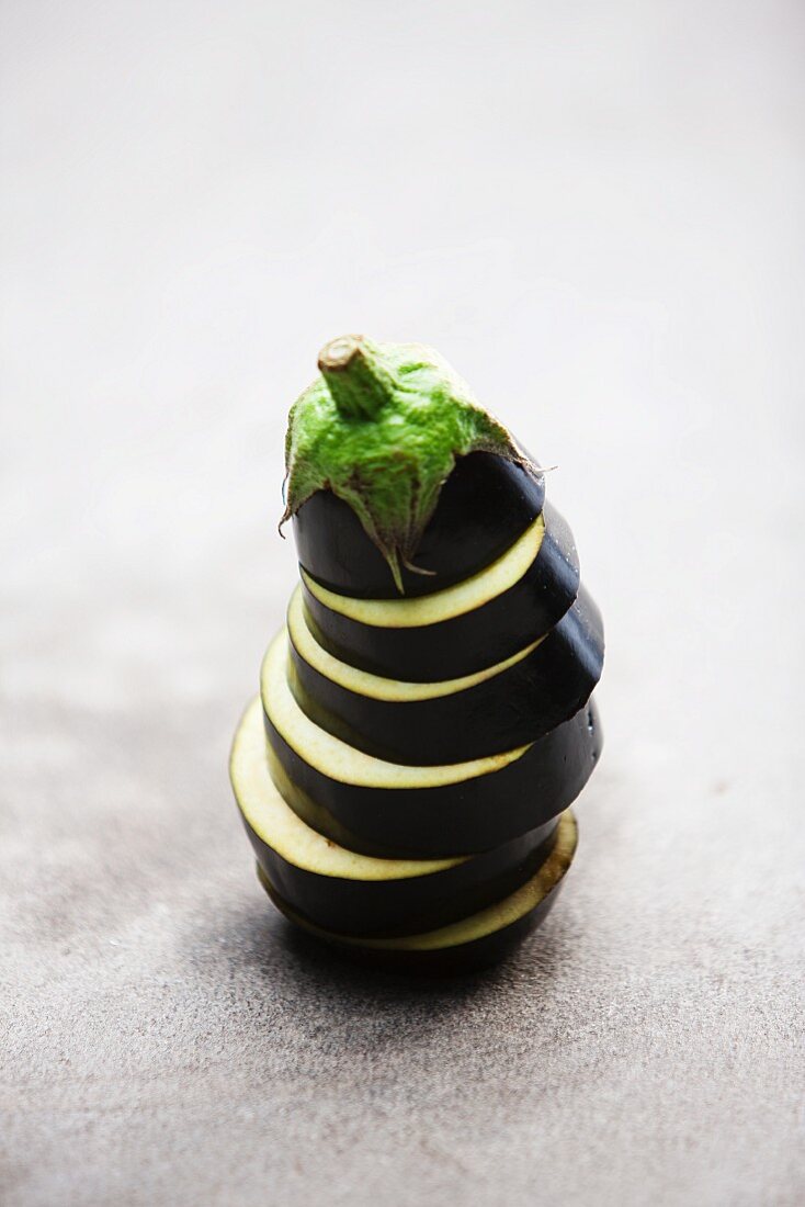 Sliced and Stacked Eggplant on White Background