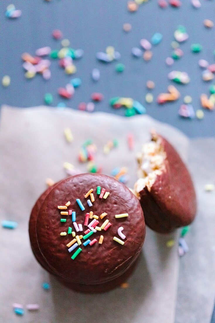 Macaroons in chocolate glaze with candy sprinkles