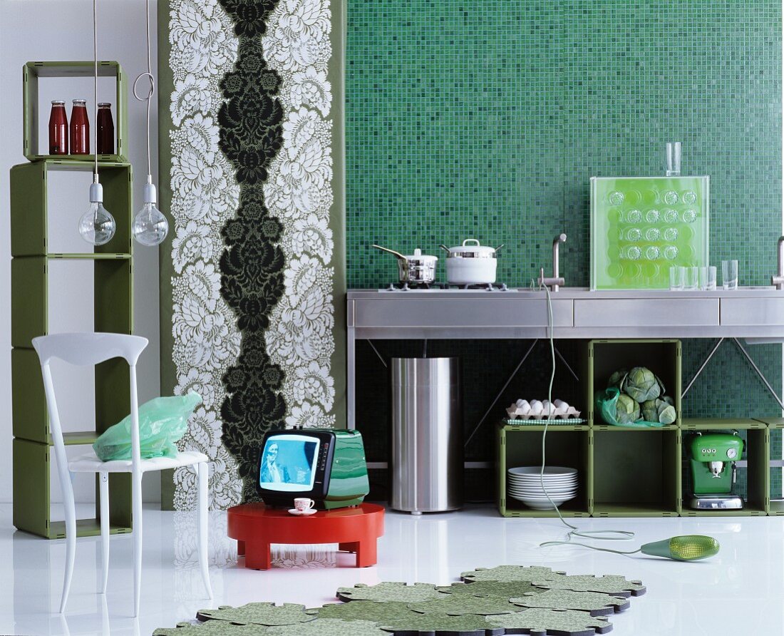 Open-plan kitchen in various shades of green