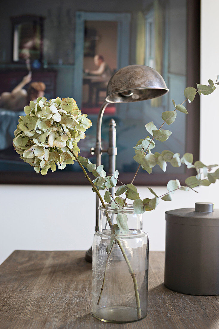 Dried flowers in apothecary jar on table